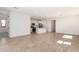 Spacious living room featuring tile flooring, neutral paint, and an open layout to the kitchen at 5352 W Las Palmaritas Dr, Glendale, AZ 85302