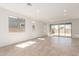 Open-concept living area with tile floors, large windows, and sliding glass doors to the backyard at 5352 W Las Palmaritas Dr, Glendale, AZ 85302