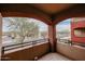 Balcony featuring views of the city street below, a tree, and neutral colored arches at 5401 E Van Buren St # 2095, Phoenix, AZ 85008