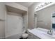 Bathroom featuring a shower-tub combo, a tile backsplash, a modern vanity, and neutral colored walls at 5401 E Van Buren St # 2095, Phoenix, AZ 85008