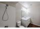 Bathroom showcasing a tiled shower, sleek vanity, wood look flooring, and modern fixtures at 5401 E Van Buren St # 2095, Phoenix, AZ 85008