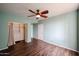 Bright bedroom featuring a closet with installed shelving, neutral walls, and wood-look flooring at 5401 E Van Buren St # 2095, Phoenix, AZ 85008