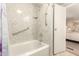 Bathroom with accessible tub, showerhead, safety bars, and a white door at 5402 E Mckellips Rd # 326, Mesa, AZ 85215