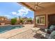 Inviting backyard with a refreshing pool, outdoor kitchen, and covered patio seating area at 5929 W Riviera Dr, Glendale, AZ 85304