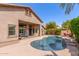 A private backyard with pool, lush greenery, and a comfortable outdoor seating area at 5929 W Riviera Dr, Glendale, AZ 85304