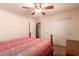 Bedroom featuring a ceiling fan and closet with sliding doors at 5929 W Riviera Dr, Glendale, AZ 85304