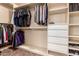 Organized walk-in closet features shelving, drawers, and ample hanging space for clothing and accessories at 5929 W Riviera Dr, Glendale, AZ 85304