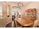 Inviting dining room features modern chandelier, and archway leading to adjacent rooms at 5929 W Riviera Dr, Glendale, AZ 85304