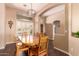 Inviting dining room features modern chandelier, plantation shutters, and archway leading to adjacent rooms at 5929 W Riviera Dr, Glendale, AZ 85304