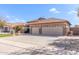 Spacious three-car garage with tile roof and desert landscaping at 5929 W Riviera Dr, Glendale, AZ 85304