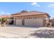 Spacious three-car garage with tile roof and desert landscaping at 5929 W Riviera Dr, Glendale, AZ 85304