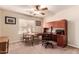 Well-lit home office with built-in desk, shelving, and comfortable seating for remote work at 5929 W Riviera Dr, Glendale, AZ 85304