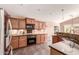 Well-lit kitchen with stainless steel refrigerator and modern appliances at 5929 W Riviera Dr, Glendale, AZ 85304