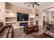 Open-concept living room featuring a built-in entertainment center with a fireplace at 5929 W Riviera Dr, Glendale, AZ 85304