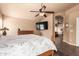 Bright and airy main bedroom with a ceiling fan and ensuite bathroom with a bathtub at 5929 W Riviera Dr, Glendale, AZ 85304