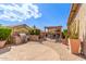 Charming backyard with outdoor kitchen, fireplace, pergola, and lounge seating area at 5929 W Riviera Dr, Glendale, AZ 85304