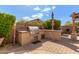 Outdoor kitchen with a stainless steel BBQ grill, stone countertops, and ample prep space at 5929 W Riviera Dr, Glendale, AZ 85304