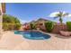 Backyard view featuring a private pool, mature landscaping, and outdoor seating at 5929 W Riviera Dr, Glendale, AZ 85304