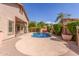 Beautiful backyard with a private pool, mature landscaping, and a covered patio at 5929 W Riviera Dr, Glendale, AZ 85304