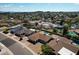 An aerial view showing a neighborhood with several homes featuring swimming pools and desert landscaping at 6759 E Aire Libre Ln, Scottsdale, AZ 85254