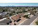 Aerial view of a home, showcasing the pool and the surrounding neighborhood with mountain views at 6759 E Aire Libre Ln, Scottsdale, AZ 85254