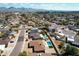 An aerial view of homes in a residential neighborhood with desert landscaping, trees, and mountain views at 6759 E Aire Libre Ln, Scottsdale, AZ 85254