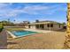 An expansive backyard featuring a sparkling pool, patio, and low-maintenance landscaping at 6759 E Aire Libre Ln, Scottsdale, AZ 85254