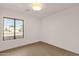 Empty bedroom with wood floors and a large window with views of the front yard at 6759 E Aire Libre Ln, Scottsdale, AZ 85254