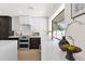 Stylish kitchen featuring white countertops, dark cabinetry, and modern fixtures at 6759 E Aire Libre Ln, Scottsdale, AZ 85254