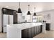 Modern kitchen with a large island, pendant lighting, and stainless-steel appliances at 6759 E Aire Libre Ln, Scottsdale, AZ 85254