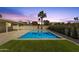 Backyard pool with grass accent is framed by landscaping and a covered patio with a great sunset view at 6759 E Aire Libre Ln, Scottsdale, AZ 85254