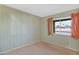 Bedroom with neutral carpet, patterned wall paper, and view to the outside at 6824 N 31 Ave, Phoenix, AZ 85017