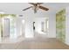 Open-plan living room with patterned wallpaper, neutral carpet, and tile floors at 6824 N 31 Ave, Phoenix, AZ 85017