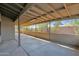 Covered patio area with beige walls, concrete floor, and concrete block barrier at 6824 N 31 Ave, Phoenix, AZ 85017