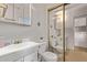 A full bathroom with a single sink vanity, toilet, and adjacent laundry at 7750 E Broadway Rd # 843, Mesa, AZ 85208