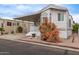 Cozy mobile home with a covered porch, mature landscaping, and appealing curb appeal at 7750 E Broadway Rd # 843, Mesa, AZ 85208