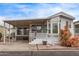 Charming mobile home featuring a covered porch, well-maintained landscaping, and a cozy exterior at 7750 E Broadway Rd # 843, Mesa, AZ 85208