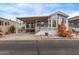 Charming mobile home featuring a covered porch, well-maintained landscaping, and a cozy exterior at 7750 E Broadway Rd # 843, Mesa, AZ 85208