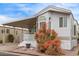 Cozy mobile home with a covered porch, mature landscaping, and appealing curb appeal at 7750 E Broadway Rd # 843, Mesa, AZ 85208