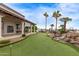 Well-manicured putting green featuring beautiful landscaping and palm trees near the Clubhouse at 7750 E Broadway Rd # 843, Mesa, AZ 85208