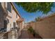 A quaint backyard with a brick pathway leading to a gate and low-maintenance landscaping at 7826 W Kerry Ln, Glendale, AZ 85308