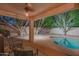 Serene covered patio view overlooking the backyard pool and seating area, perfect for relaxation at 7826 W Kerry Ln, Glendale, AZ 85308