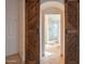 Elegant bathroom showcasing wood sliding doors, tiled shower and an archway entry at 7826 W Kerry Ln, Glendale, AZ 85308