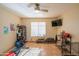 Versatile bonus room with natural light and a ceiling fan, adaptable for various uses like a gym or office at 7826 W Kerry Ln, Glendale, AZ 85308