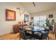 A dining room with travertine floors, a round table with seating for six, and a modern buffet at 7826 W Kerry Ln, Glendale, AZ 85308