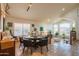 Open-concept dining room featuring travertine floors, high ceilings, and abundant natural light at 7826 W Kerry Ln, Glendale, AZ 85308