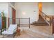 The entryway features travertine steps, a wood-paneled door, and a stylish railing at 7826 W Kerry Ln, Glendale, AZ 85308