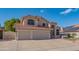 Charming two-story home with a well-manicured front lawn, a three-car garage, and a classic tile roof at 7826 W Kerry Ln, Glendale, AZ 85308