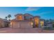 Elegant two-story residence featuring a tile roof, manicured landscaping, and a spacious driveway at 7826 W Kerry Ln, Glendale, AZ 85308