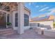 Charming home exterior featuring a tile roof, desert landscaping, a flagstone patio, and solar panels at 7826 W Kerry Ln, Glendale, AZ 85308